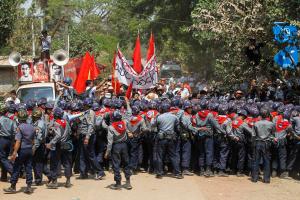 Student protesters fight with police while trying to break a police line in Letpadan